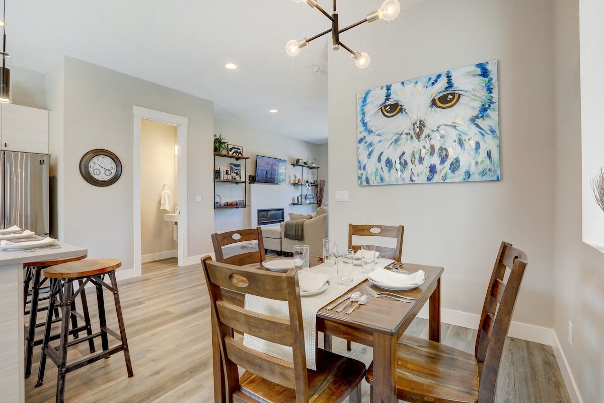 Dining area with bar stools and a large owl painting