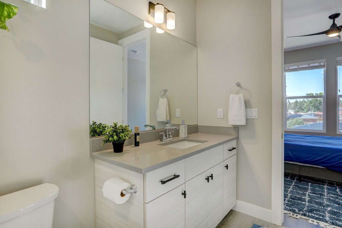 Bathroom vanity with a bedroom visible beyond