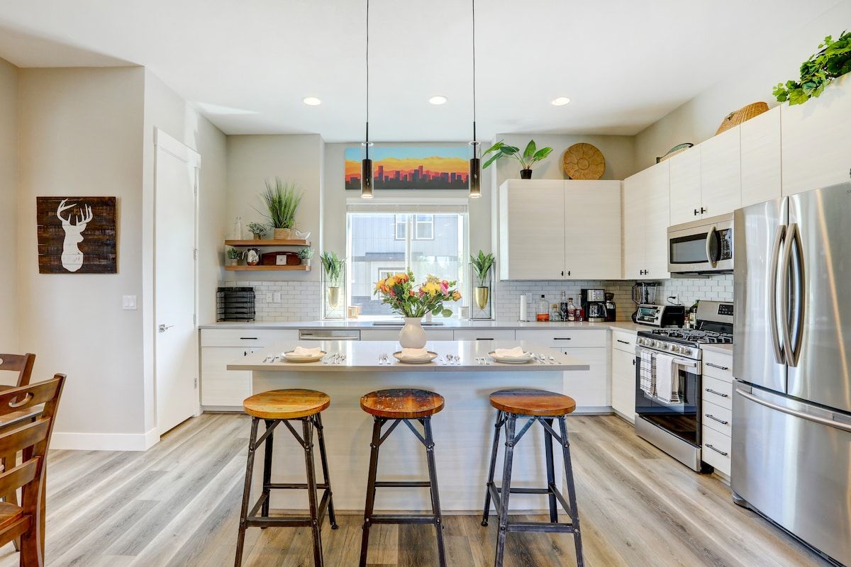 Kitchen island with stools and stainless appliances