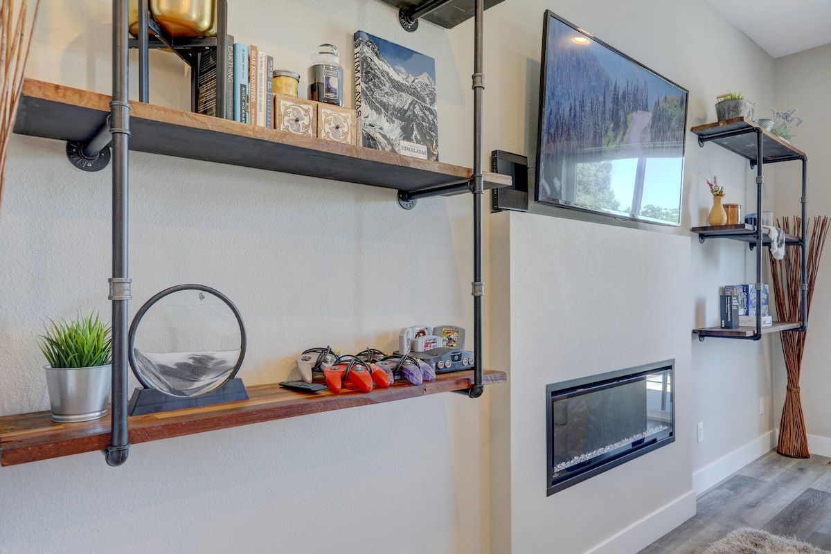 Shelving wall with a TV above the fireplace