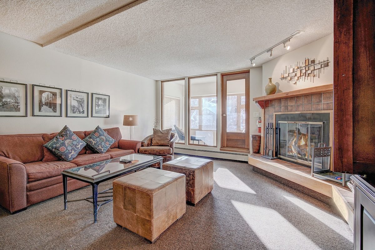 Living room with a sofa and a wood burning fireplace