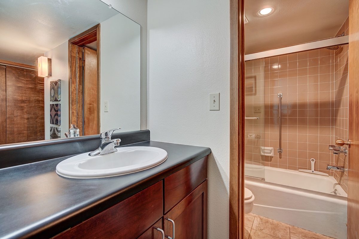 Bathroom with a wide vanity and a tub and shower