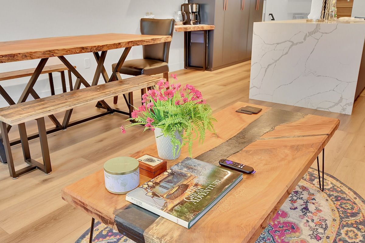 Wooden dining table handcrafted by the owner, with bench seating