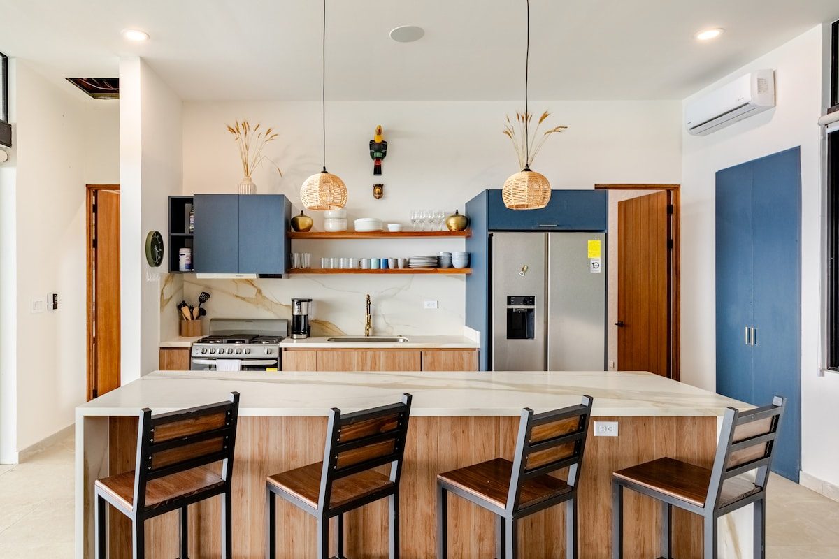 Kitchen with a breakfast bar and blue cabinets
