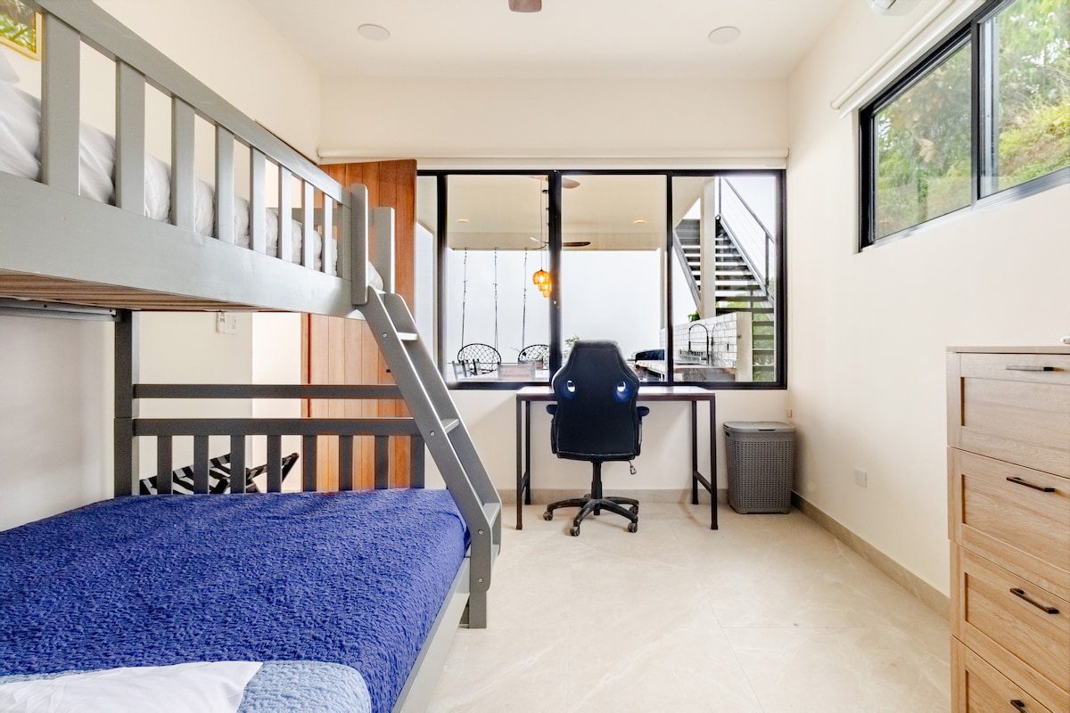 Loft room with a raised bunk and a desk